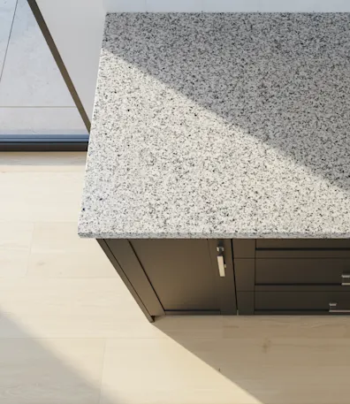 blue gray kitchen cabinets with a white speckled solid surface countertop