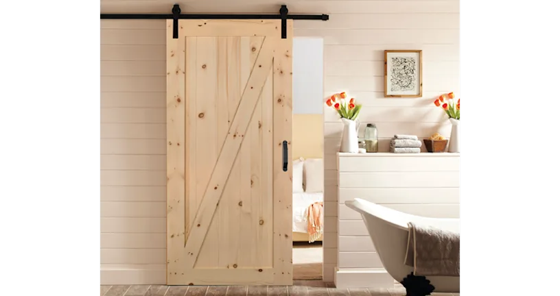 Masonite interior sliding barn door in knotty pine finish