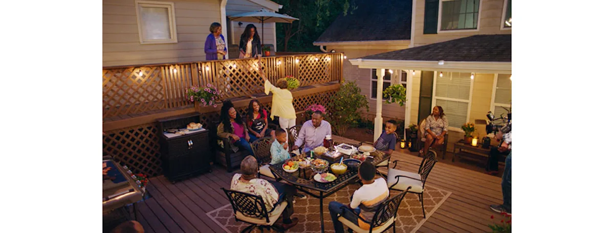 A backyard double deck with string lights
