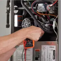 Hands working on an HVAC system; orange tools icon