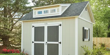 Yellowish beige TuffShed with gray double doors