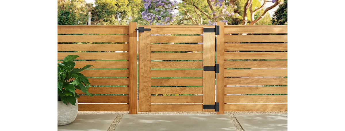 A modern horizontal fence with a swinging gate and black hardware
