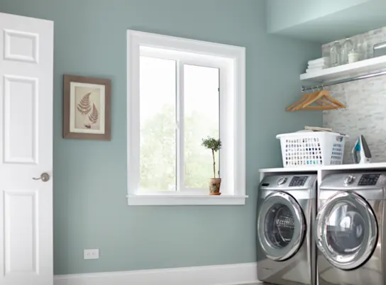 a white laundry room sliding window
