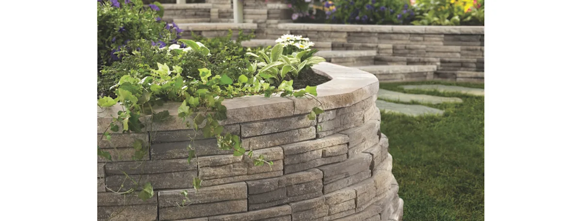 A curved garden decorative block wall filled with plants