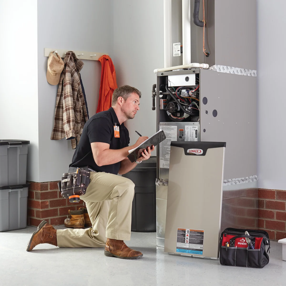 HD service pro conducting a routine maintenance check on a customer's HVAC unit