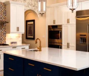 Modern, bright kitchen with white marble countertops; orange dollar sign flag icon