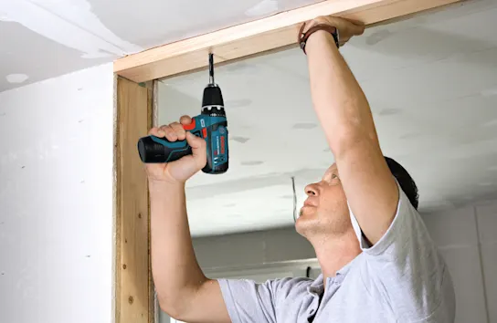 Service pro working on the framing for a closet door
