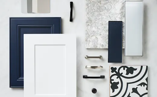 Kitchen material samples laid out on a table including tile and wood.