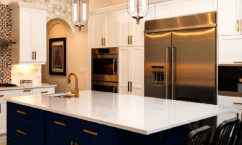 Modern, bright kitchen with white marble countertops; orange dollar sign flag icon