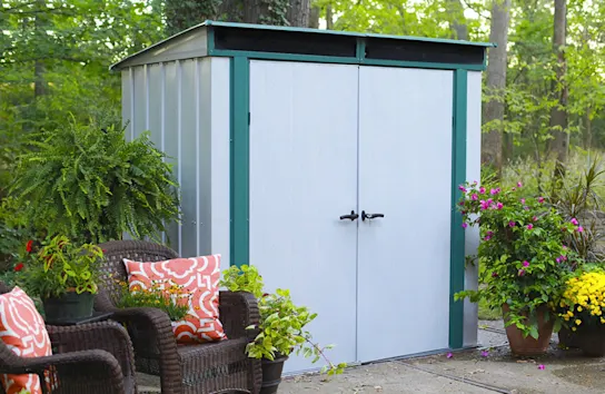 Lean-to shed in a lush green patio space