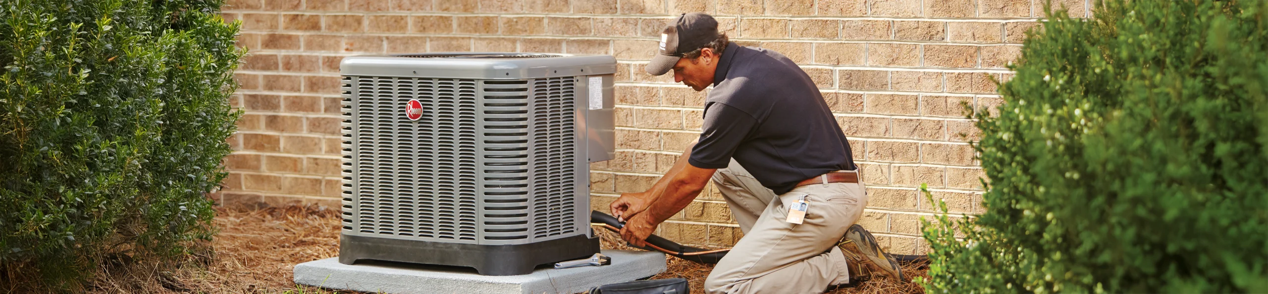 HD Service pro installing an HVAC unit outside of a customer's home
