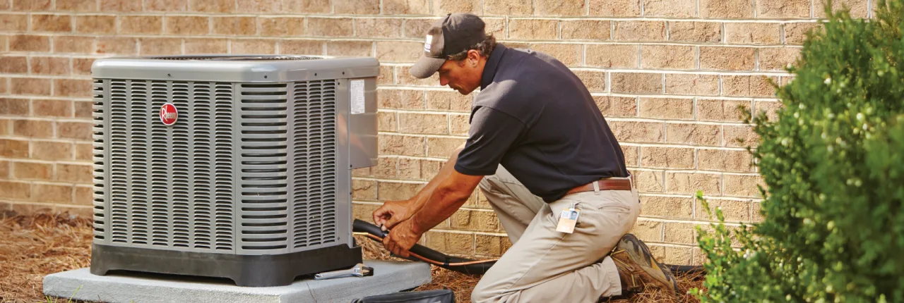 HD Service pro installing an HVAC unit outside of a customer's home