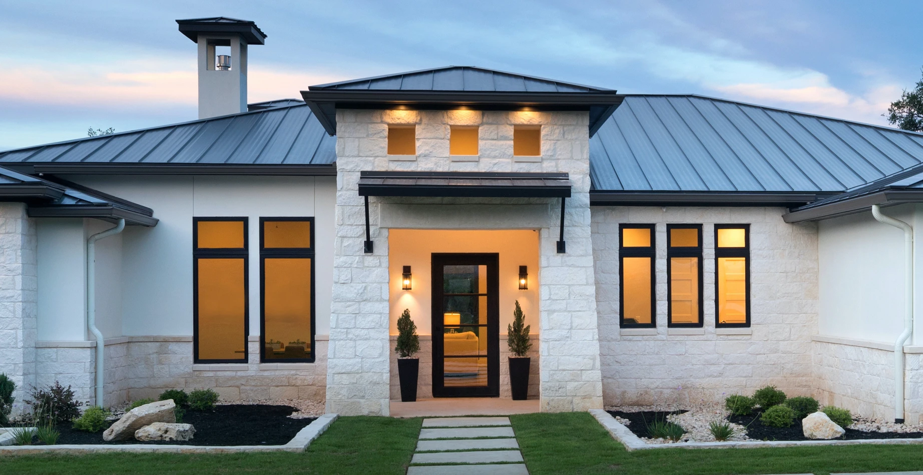 a white stucco home with wooden black framed windows