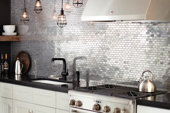 a kitchen with a metal backsplash