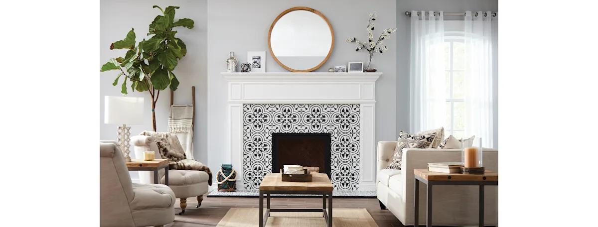 A white craftsman fireplace with a pattern tile