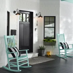 A black front door to a home with two blue porch chairs; orange door icon