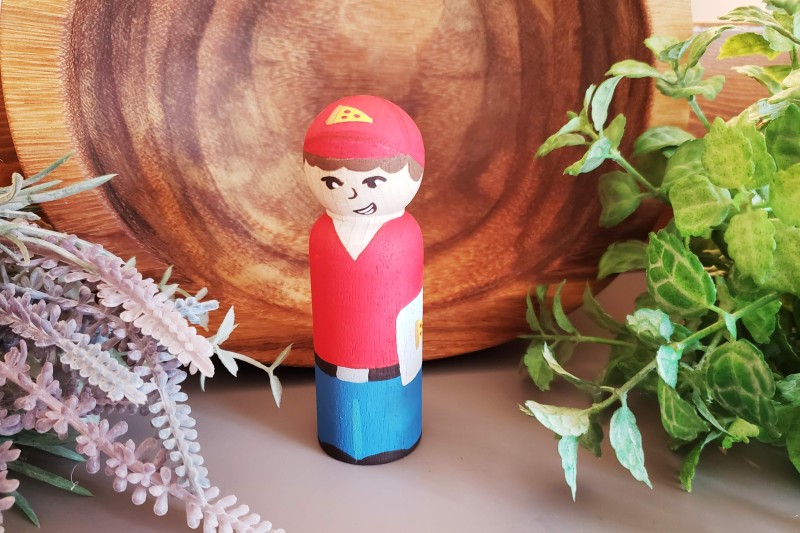 Pizza boy with foliage in the background