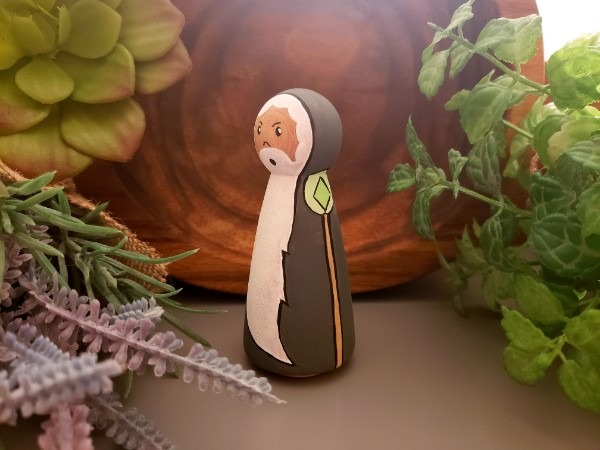 Wizard peg doll standing in a jungle