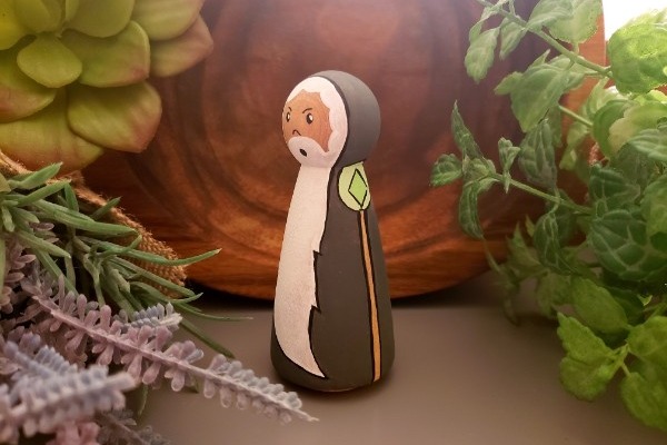 Wizard peg doll standing in a jungle