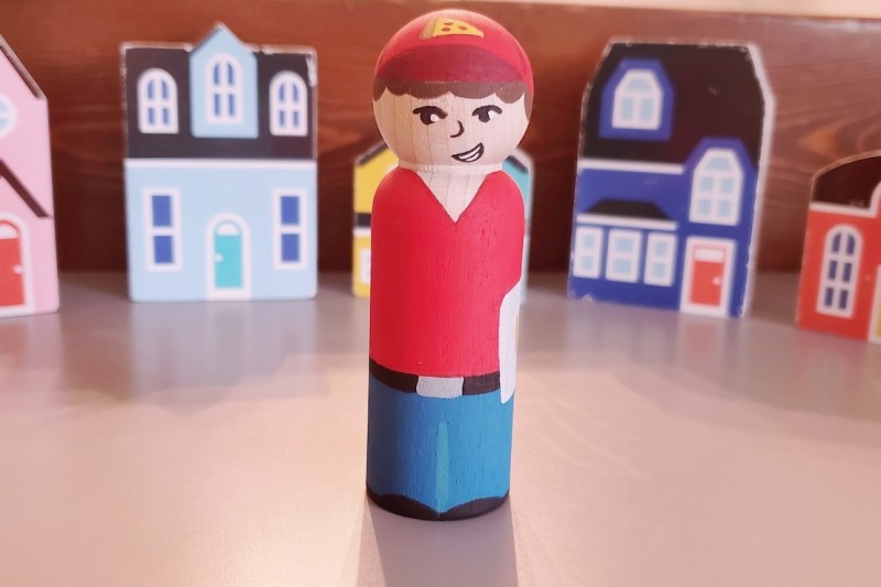 Pizza boy with buildings in the background