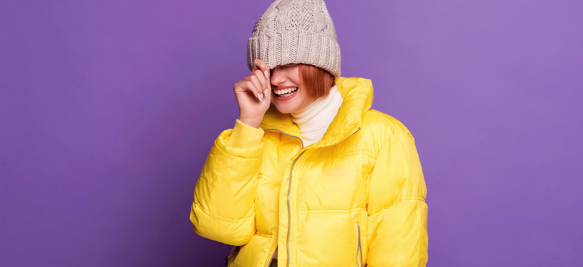 Woman smiling in a bright yellow topcoat