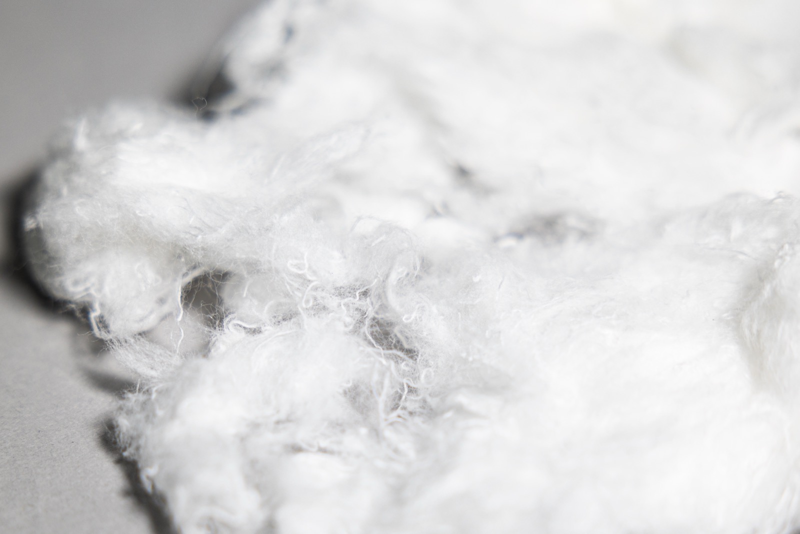 Recycled cotton fibre recovered from polyester-cotton blended textile waste.