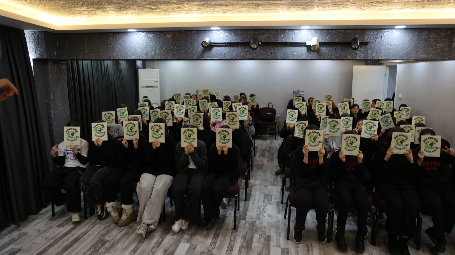 Students with the programme's education booklets after a session.