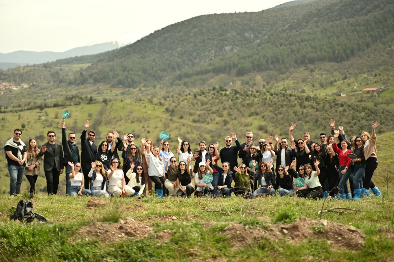 Employees and business partners at the tree-planting event marking 500,000 saplings