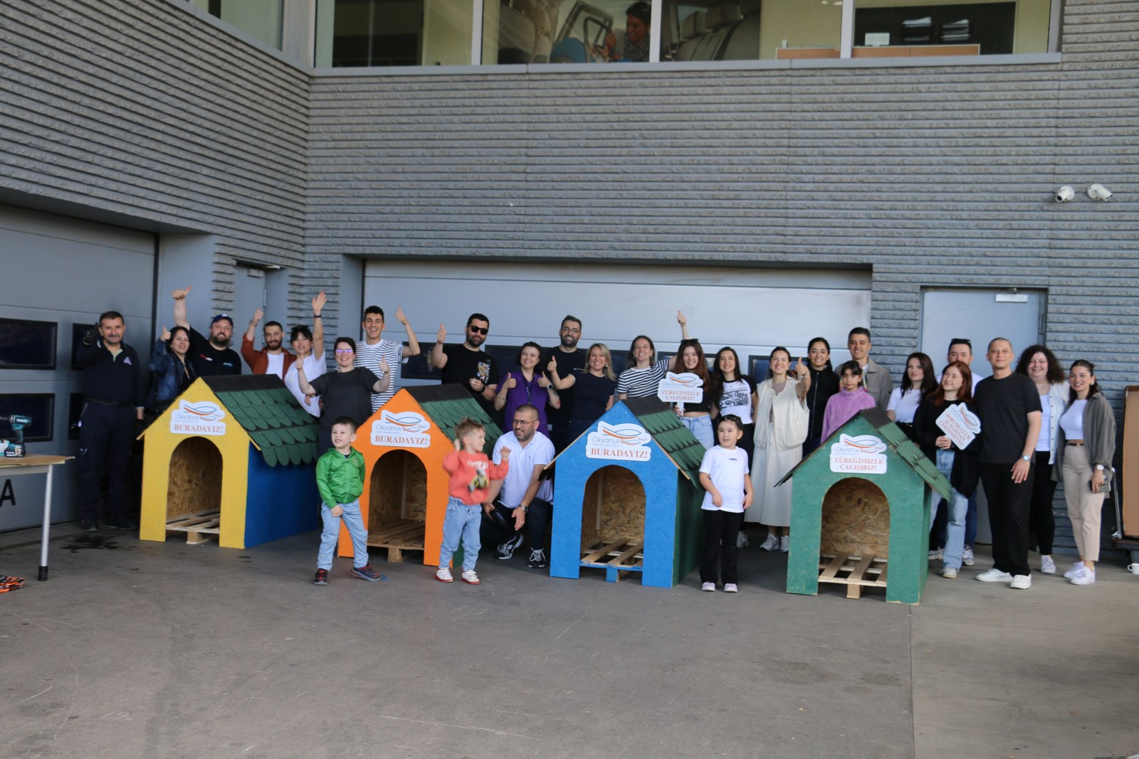 CS311 Inside 1 Animal shelters built from idle workshop pallets, with the volunteer team that assembled them