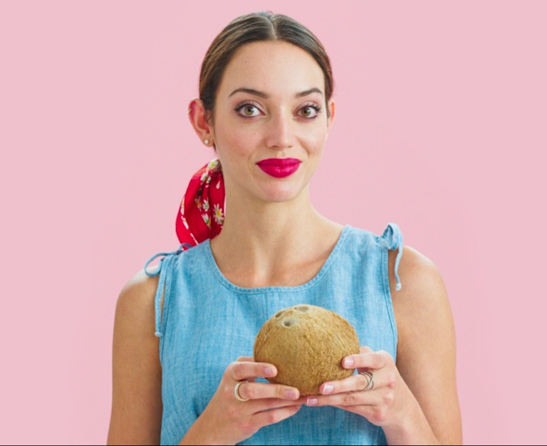 Woman holding a coconut