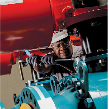 closeup view of man working on a valve