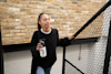 woman walking upstairs holding a huel shaker