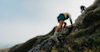 two people hiking up a steep mountain