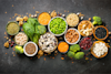 Top view of different vegan protein sources in bowls - including peas nuts grains and more