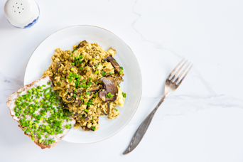 Scramble tofu with mushrooms, vegan alternative. White background.