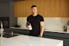 matt morsia in a kitchen holding a huel shaker