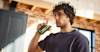 man drinking Huel Daily Greens from a Huel bottle