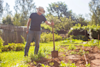 man gardening holding a spade