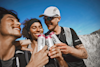 Three people drinking Huel Daily A-Z Vitamin & Minerals energy drinks whilst smiling