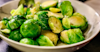 cooked brussel sprouts cut in half and in a bowl