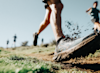 close up of a trail runners running shoe in action running over mud