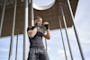 a man outside in a boxing pose wearing wrist wraps