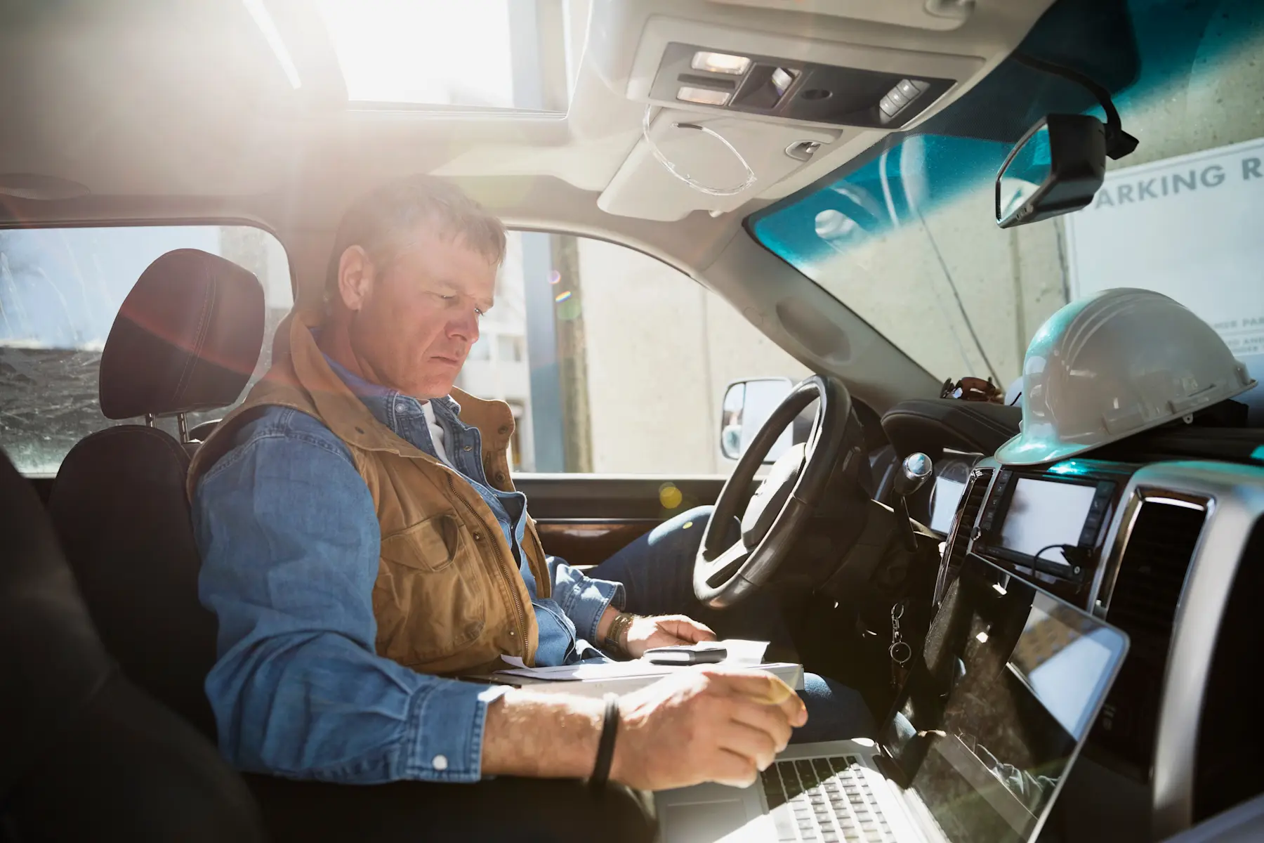 Worker looking at computer in truck