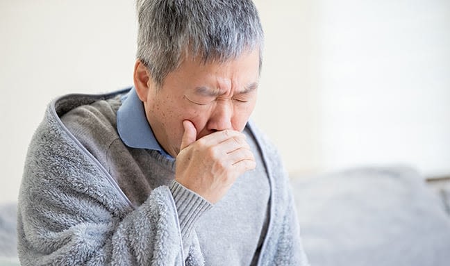 Older person coughing