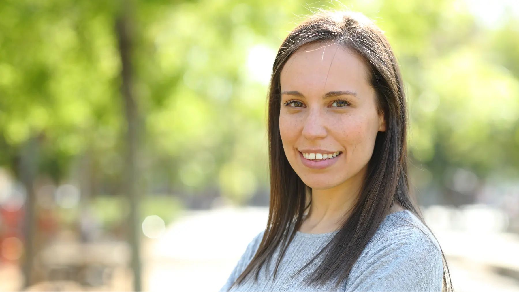 A woman with a clean and bright smile referencing how to get rid of sensitive teeth