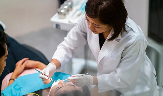 Dentist checking patient’s teeth