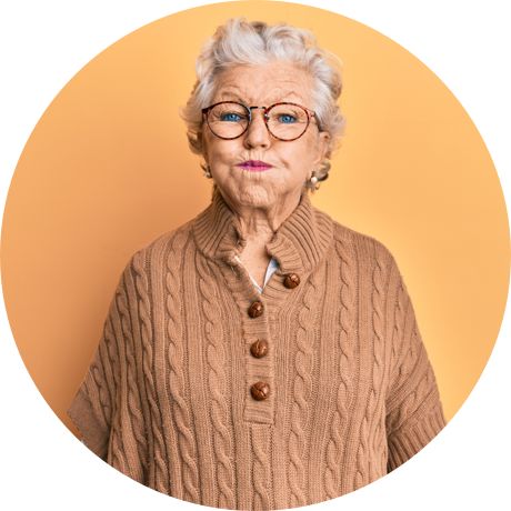 Older woman standing and holding mouthwash in her mouth