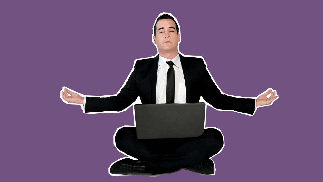 A man in a tuxedo with a laptop while meditating - breathe in. breathe out. Man