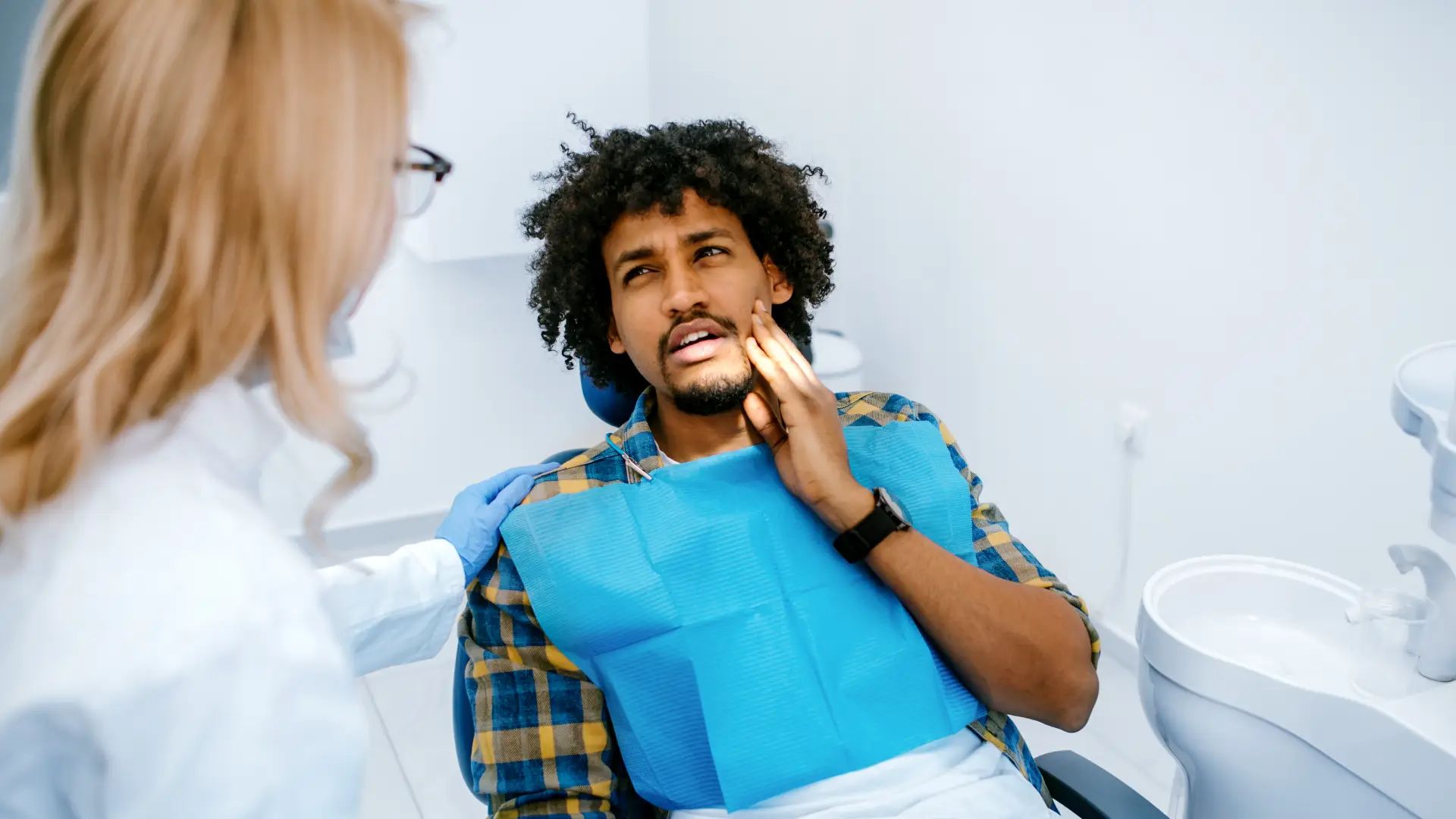 Man at a dental checkup with tooth pain