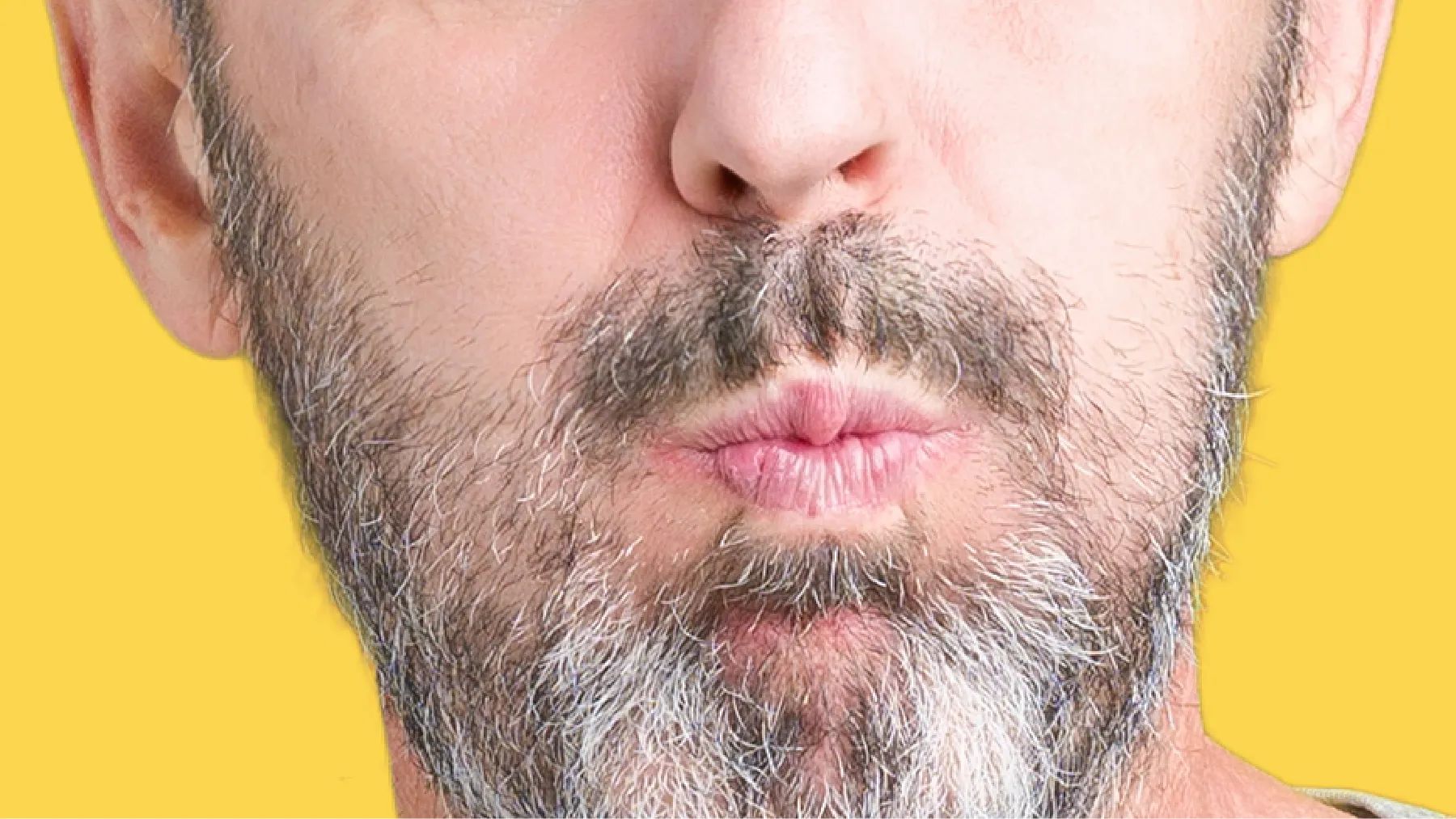 What is halitosis? Close-up of a bearded man making a rinsing gesture with his mouth